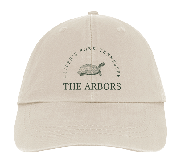 Embroidered apparel mockup featuring The Arbors branding and a custom turtle graphic on a ball cap.