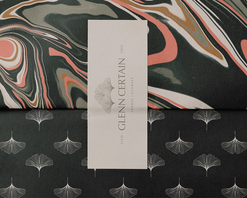 Gift wrap mockup featuring two pattern variations for Glenn Certain Florals and Events with an overlapping primary brand logo label.